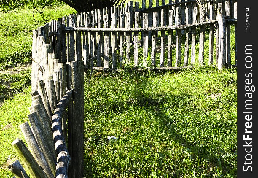 Old classic nice wooden fence in the summer meadow