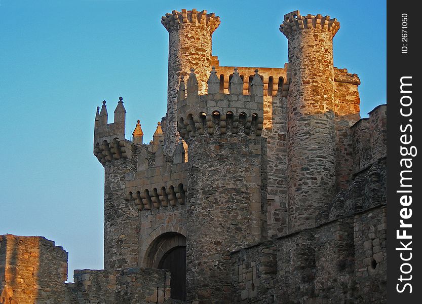 Setting sun cast sunlight onto medieval stone castle. Setting sun cast sunlight onto medieval stone castle