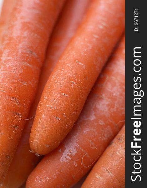 Uncooked and unwashed organic carrots. Uncooked and unwashed organic carrots