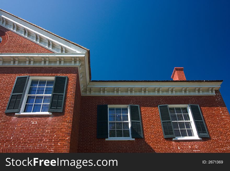 Classic brick house with blue sky background