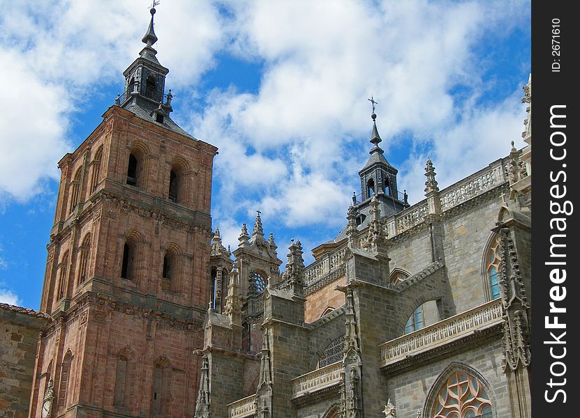 Cathedral with tower against cloudy blue sky. Cathedral with tower against cloudy blue sky