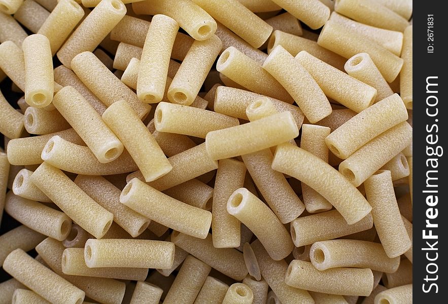 Uncooked Macaroni dried pasta tubes. Uncooked Macaroni dried pasta tubes