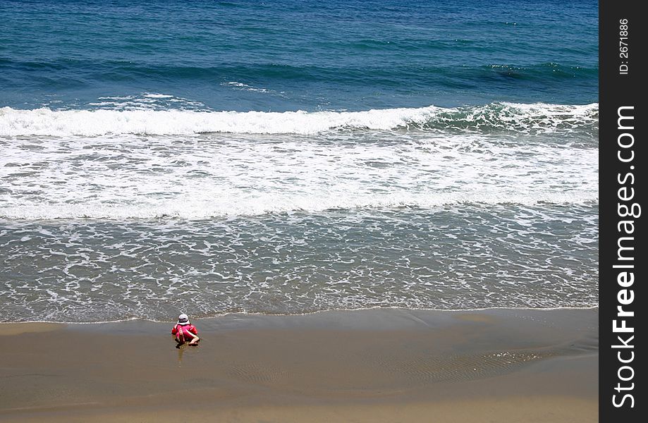 Lone toddler dangerously near the water's edge. Lone toddler dangerously near the water's edge
