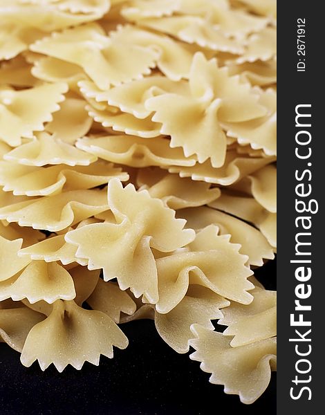 Uncooked farfalle dried pasta shapes. Uncooked farfalle dried pasta shapes