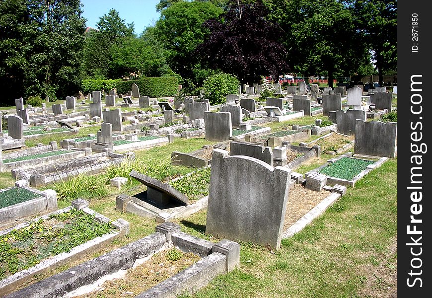 A photograph of a graveyard or cemetery. A photograph of a graveyard or cemetery.