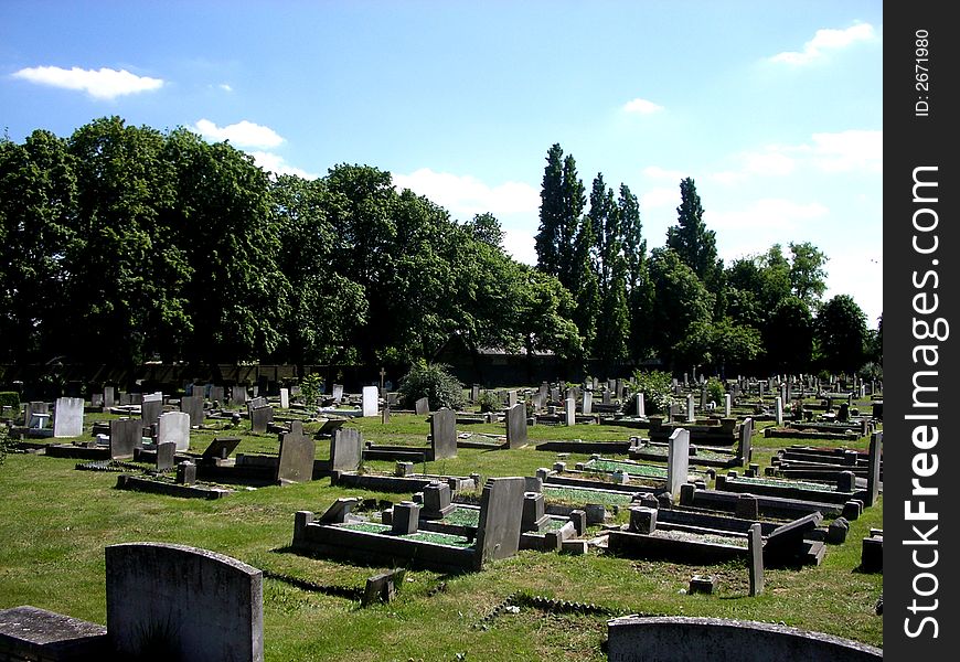 A photograph of a graveyard or cemetery. A photograph of a graveyard or cemetery.