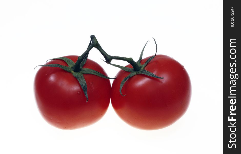 Two red tomatoes against a white background