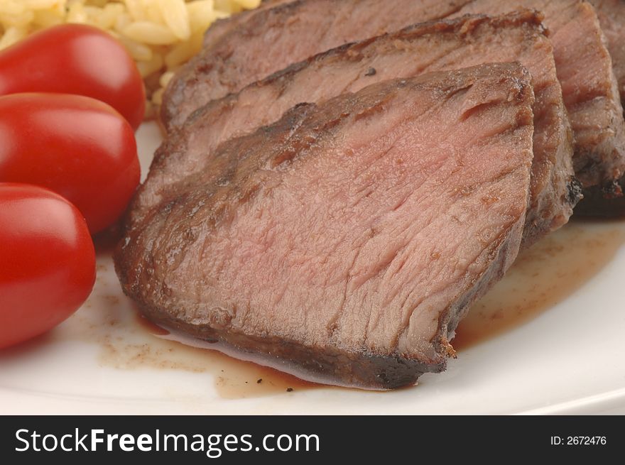 Closeup of barbecues teryaki steak and tomatoes. Closeup of barbecues teryaki steak and tomatoes.