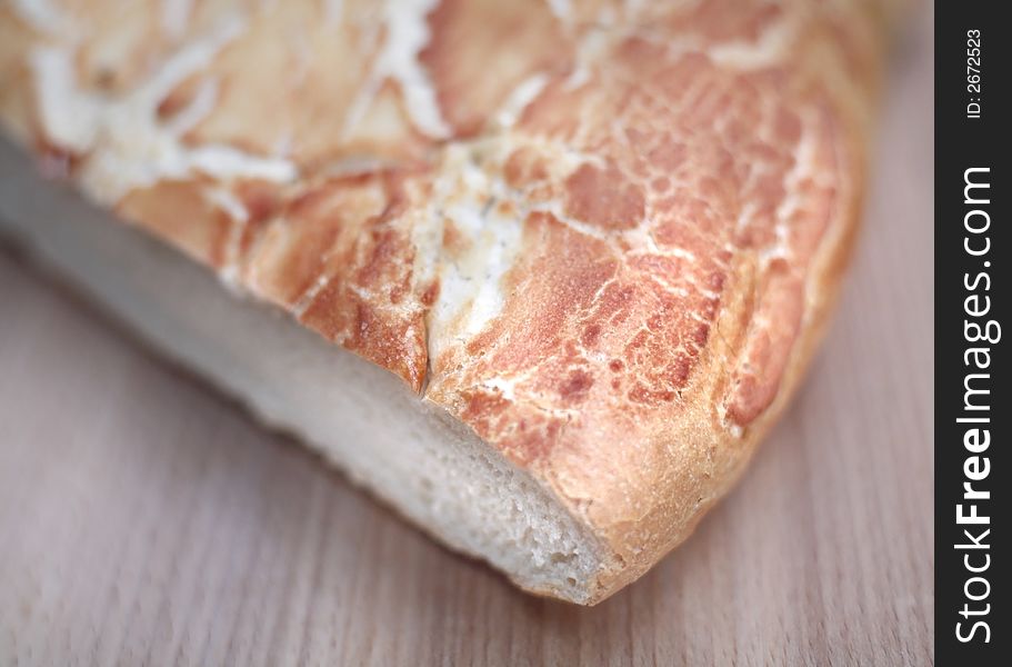 A loaf of fresh tiger bread on chopping board