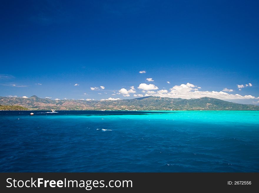 Ocean view of beautiful caribbean blue water beside a secluded white sand beach. Ocean view of beautiful caribbean blue water beside a secluded white sand beach