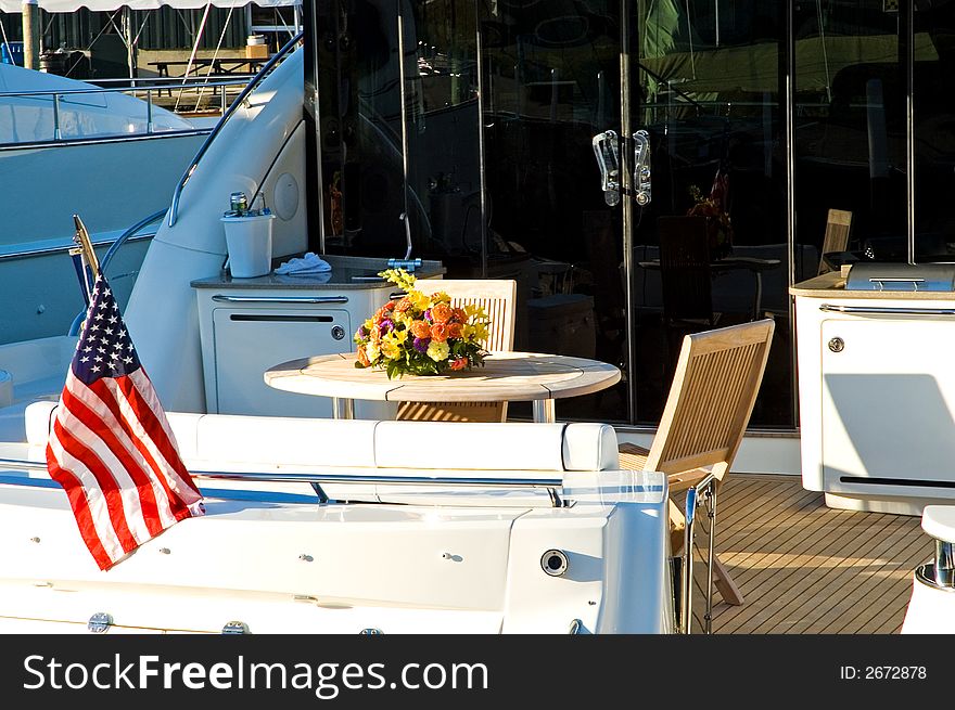 Aft deck of a private luxury yacht at a marina on an early spring morning.