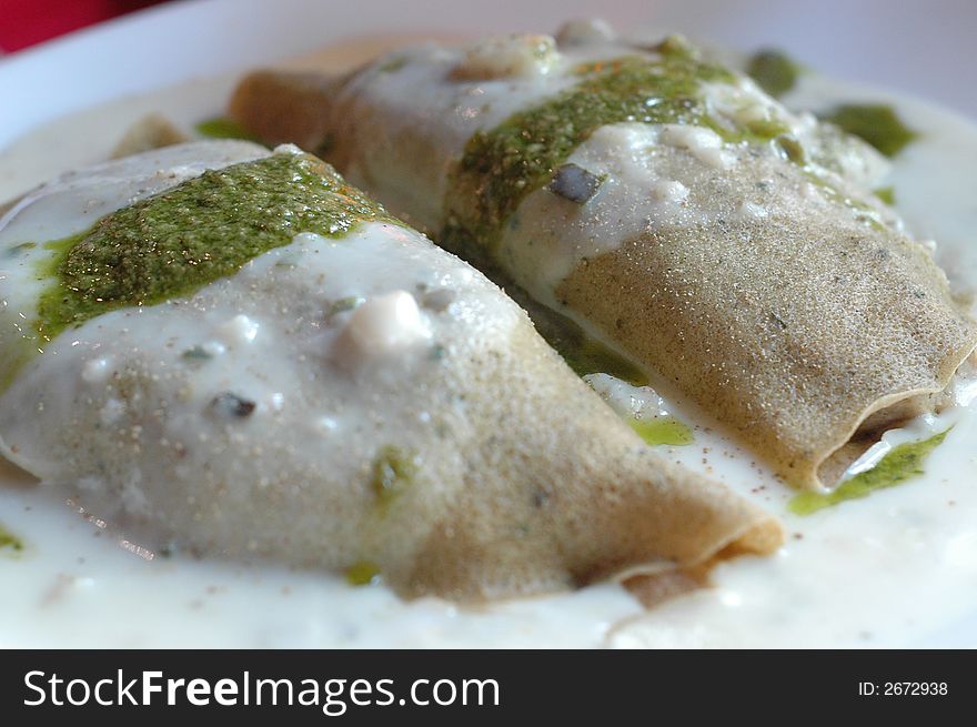 French crepes with cream sauce and green pesto