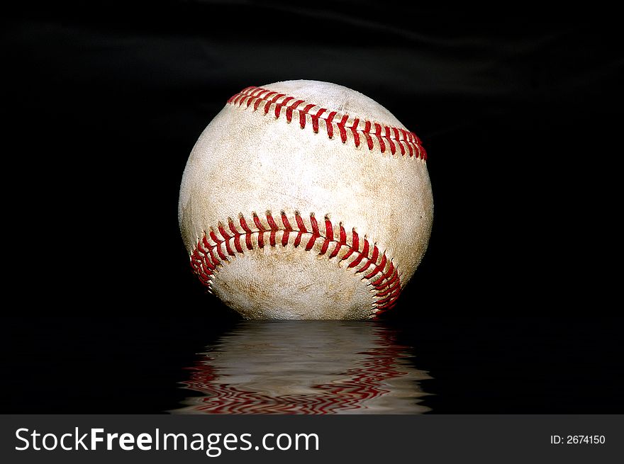Closeup shot of a used baseball against a black background