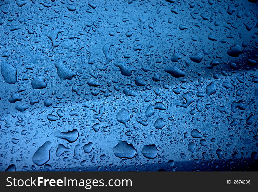 Water droplets and light on the car surface
