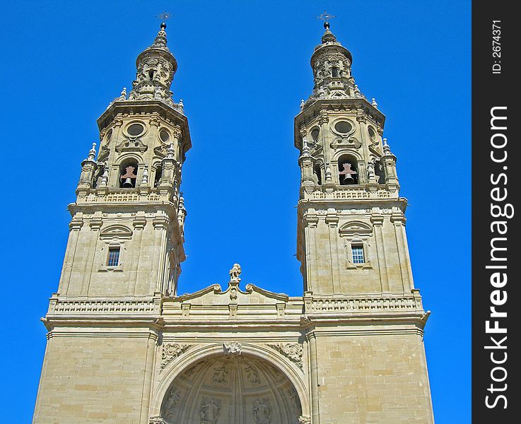 Two tall bell towers of cathedral reach up to clear blue sky. Two tall bell towers of cathedral reach up to clear blue sky