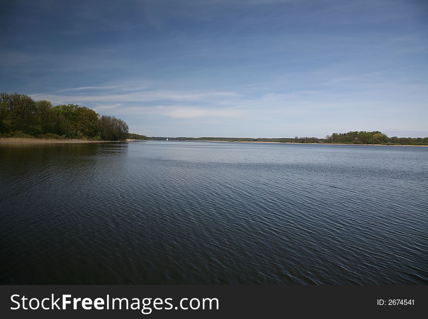 Lake landscape with clouds in spring