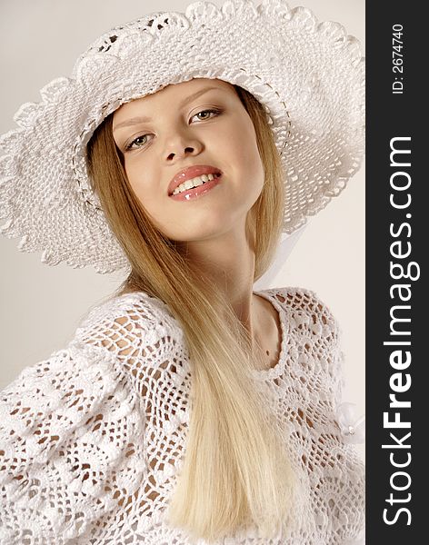 The girl in a white knitted hat and a blouse. The girl in a white knitted hat and a blouse