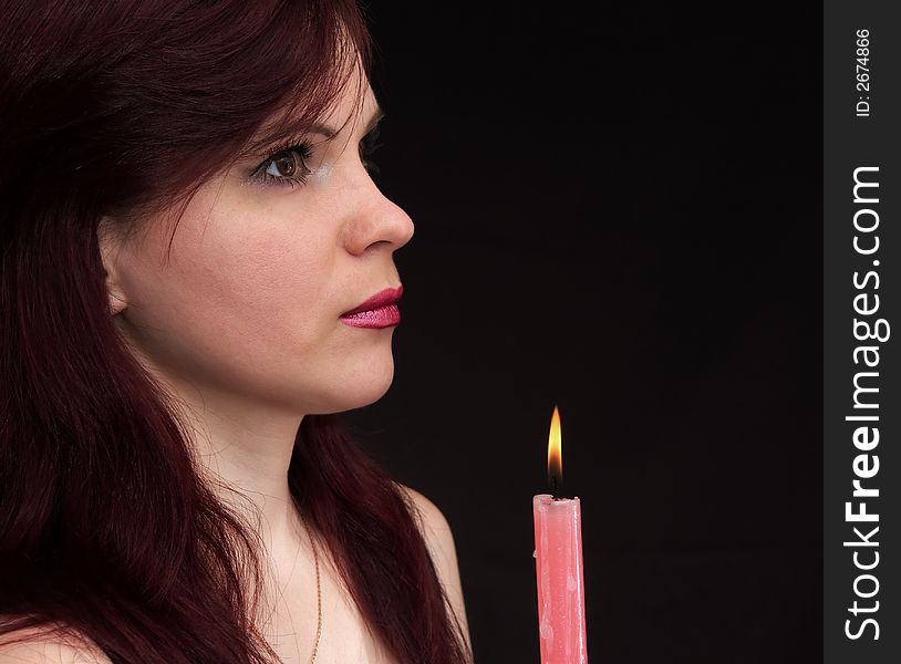 Girl and burning red candle. Girl and burning red candle