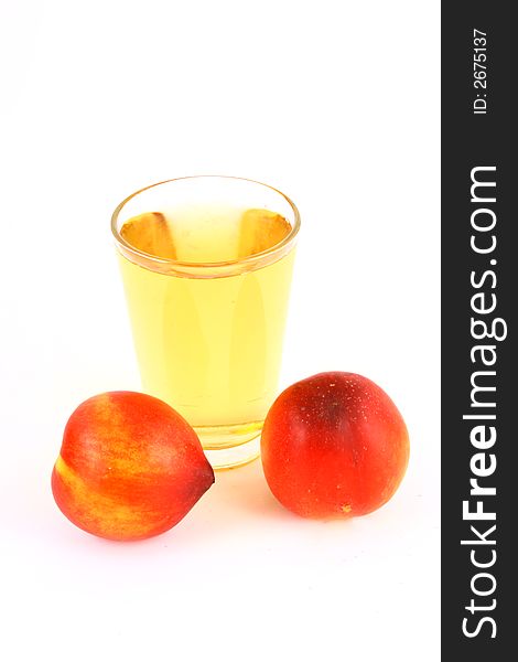 Glass of icetea and nectarine fruit - close-up. Glass of icetea and nectarine fruit - close-up