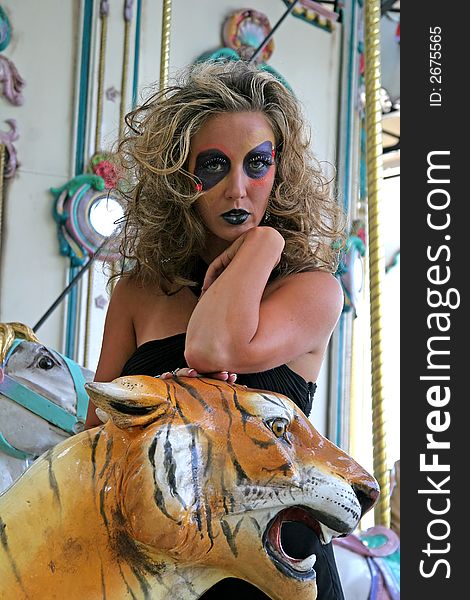 Fashion makeup model on carousel with tiger. Fashion makeup model on carousel with tiger