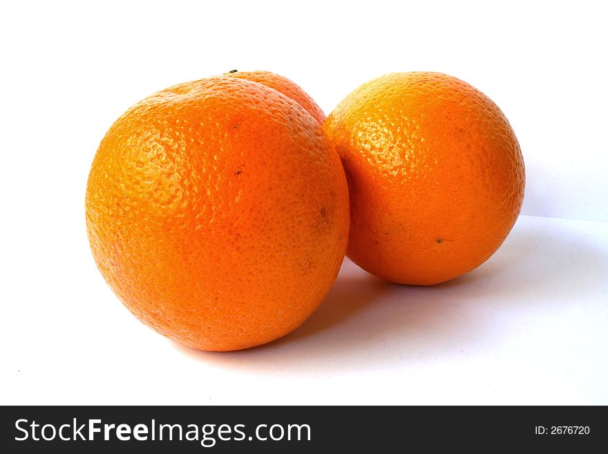 Three fresh oranges on a white background. Three fresh oranges on a white background