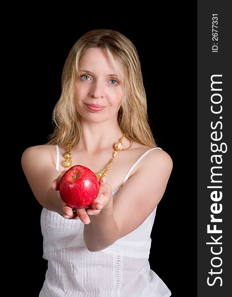 A pretty woman holding an apple. Focus on apple. A pretty woman holding an apple. Focus on apple