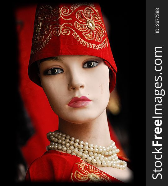 Mannequin with turkish hat, robes, and pearls