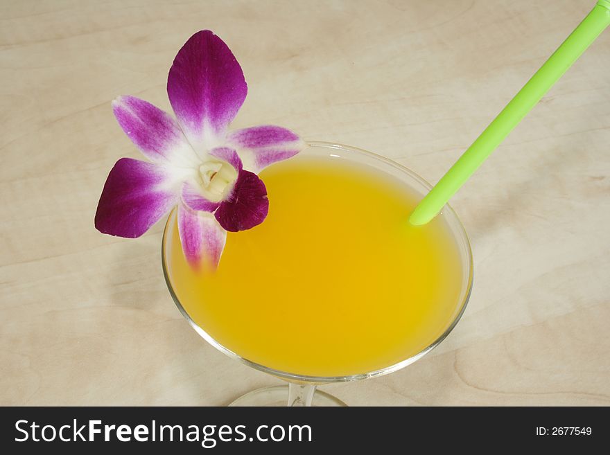 Fresh orange drink and orchid flower