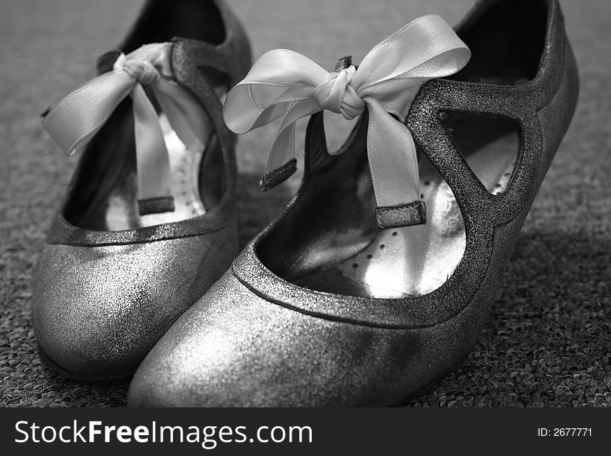 A pair of shiny shoes with ribbons, in black and white. A pair of shiny shoes with ribbons, in black and white.