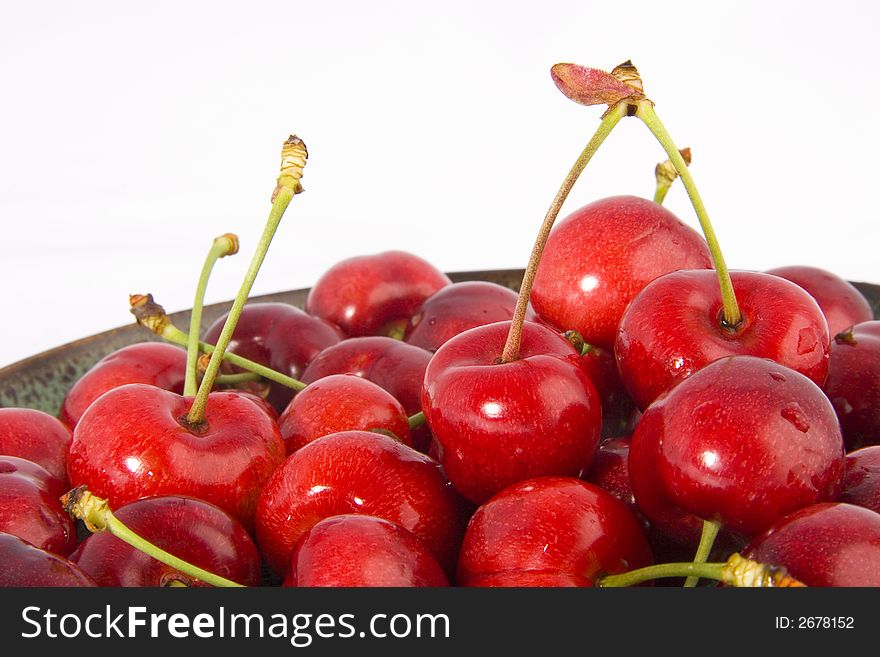 Photo of the plate with cherries on the white background. Photo of the plate with cherries on the white background