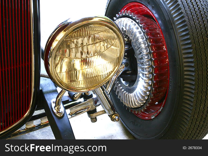 Detail of headlight , grill, and wheel of a street rod. Detail of headlight , grill, and wheel of a street rod