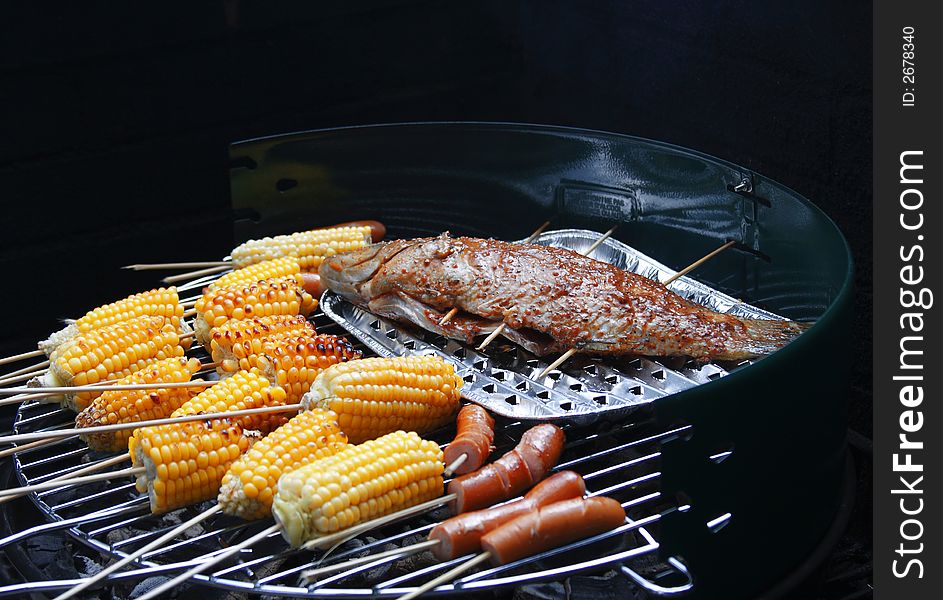 Barbecue Set with Grilled Fish, Sweet Corns and Hotdogs. Barbecue Set with Grilled Fish, Sweet Corns and Hotdogs.