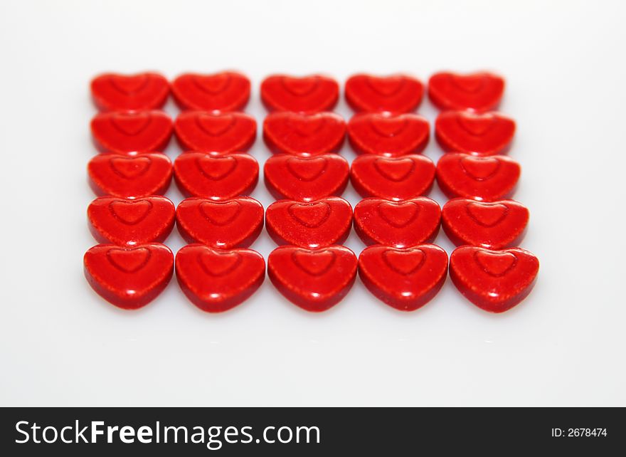 A close up of very red heart shaped candies. A close up of very red heart shaped candies