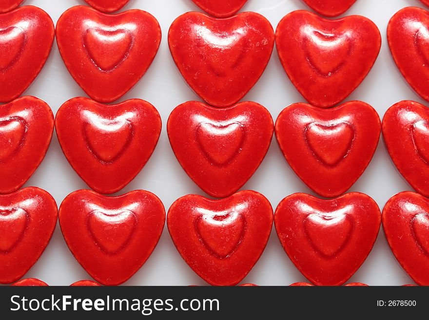 A close up of very red heart shaped candies