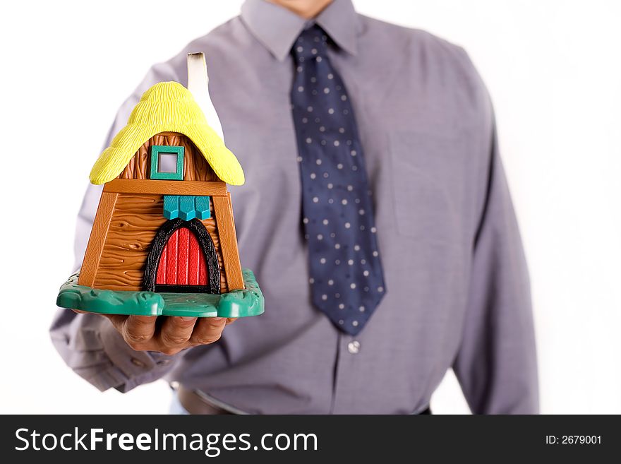 Man is holding a holida house, real estate concept. Man is holding a holida house, real estate concept