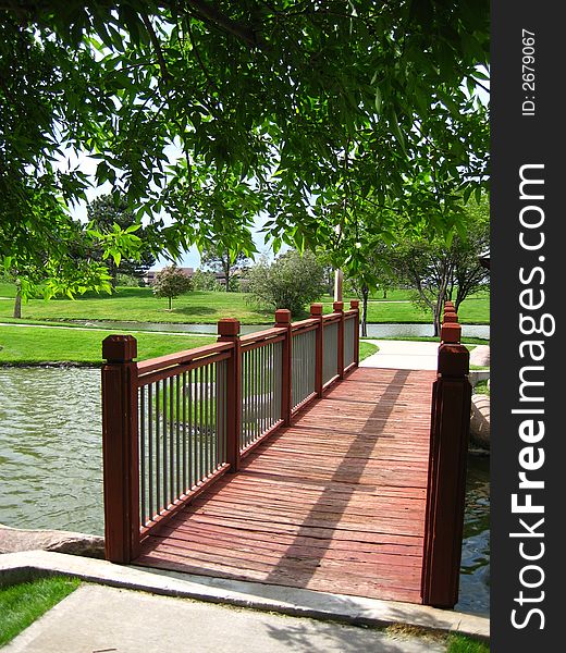 A bridge over a pond in a park in Colorado. A bridge over a pond in a park in Colorado