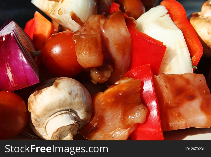 Skewered meat and vegetables on a grilling pin ready to be grilled. Skewered meat and vegetables on a grilling pin ready to be grilled.