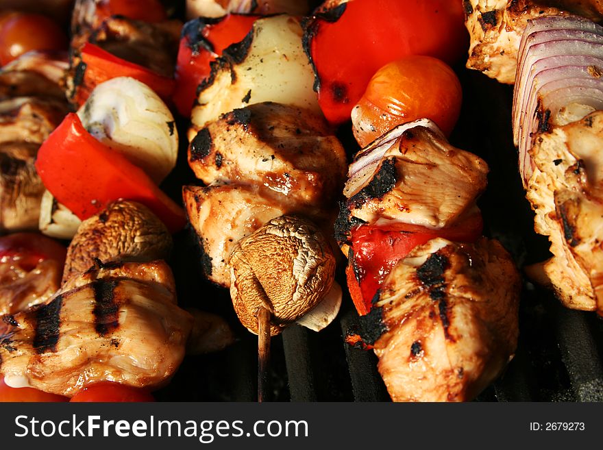 Skewered meat and vegetables on a grilling pin ready to be grilled. Skewered meat and vegetables on a grilling pin ready to be grilled.