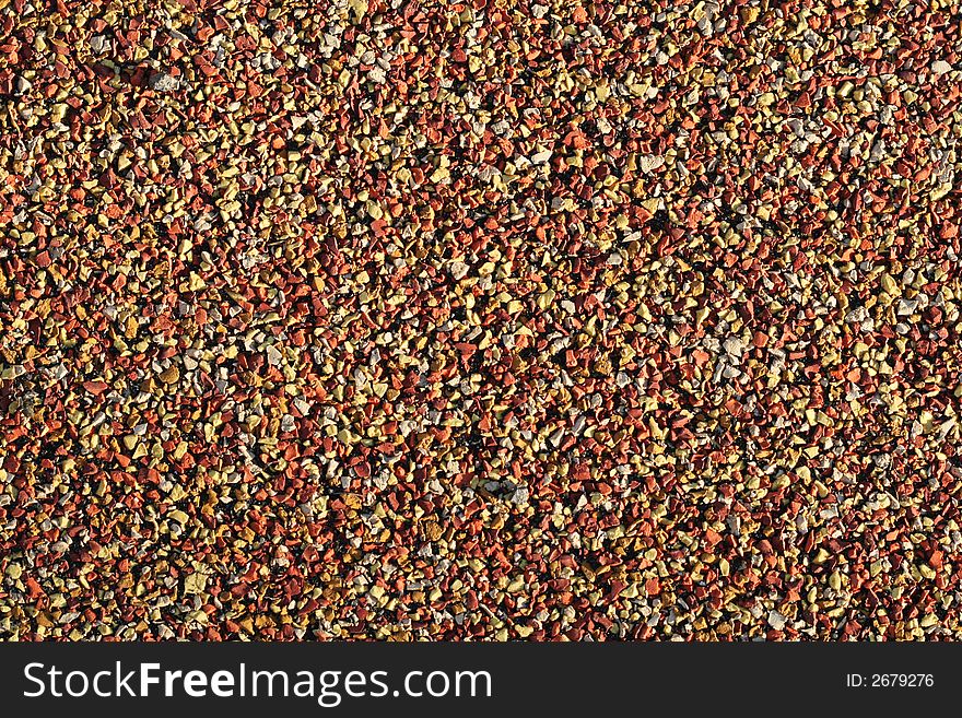 Macro shot of colorful gravel pavement,orange and yellow. Macro shot of colorful gravel pavement,orange and yellow