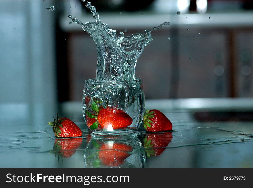 Strawberry and water spray on the table