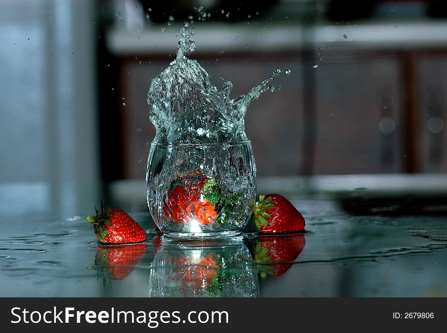 Strawberry and water spray on the table