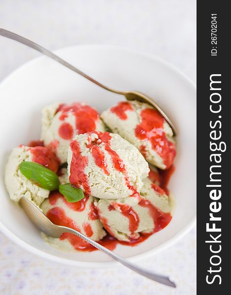 Yogurt avocado ice cream with strawberry sauce