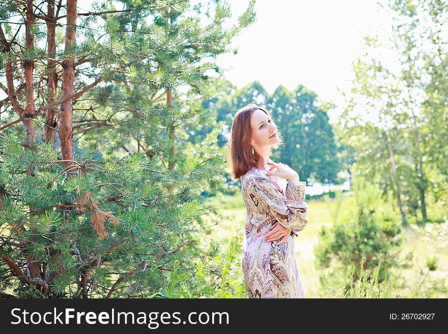 Portrait of a beautiful European woman on a background of a forest. Portrait of a beautiful European woman on a background of a forest.