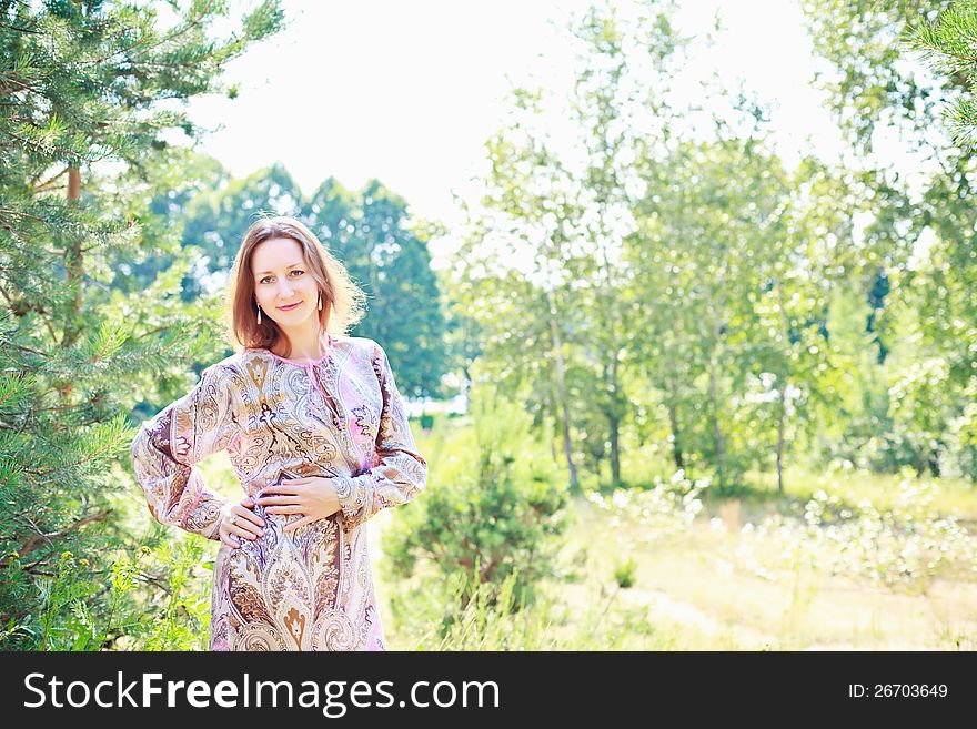 Portrait of a beautiful European woman on a background of a forest. Portrait of a beautiful European woman on a background of a forest.