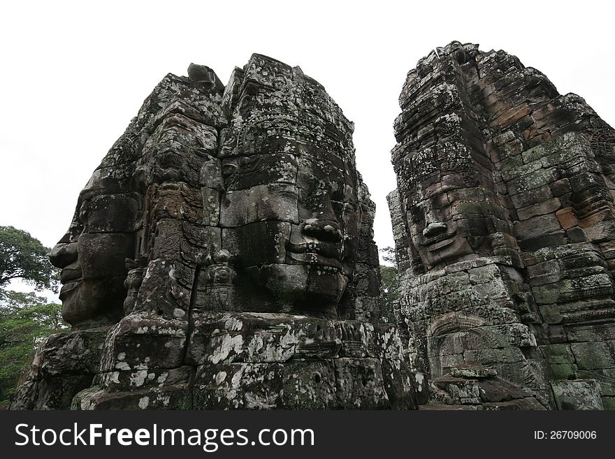 Famous stone faces at the Bayon temple in Angkor, Cambodia. Famous stone faces at the Bayon temple in Angkor, Cambodia.