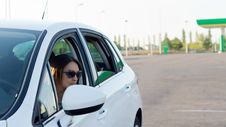 Female Driver Leaving A Gas Station Stock Photos Female Driver Leaving A Gas Station Stock Photos