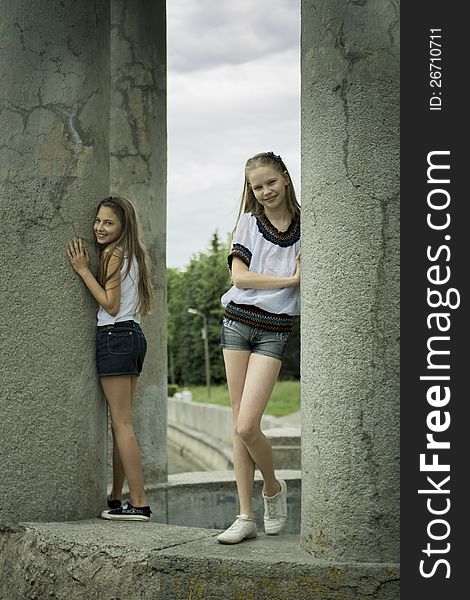 Two teenage girls playing in the park near river