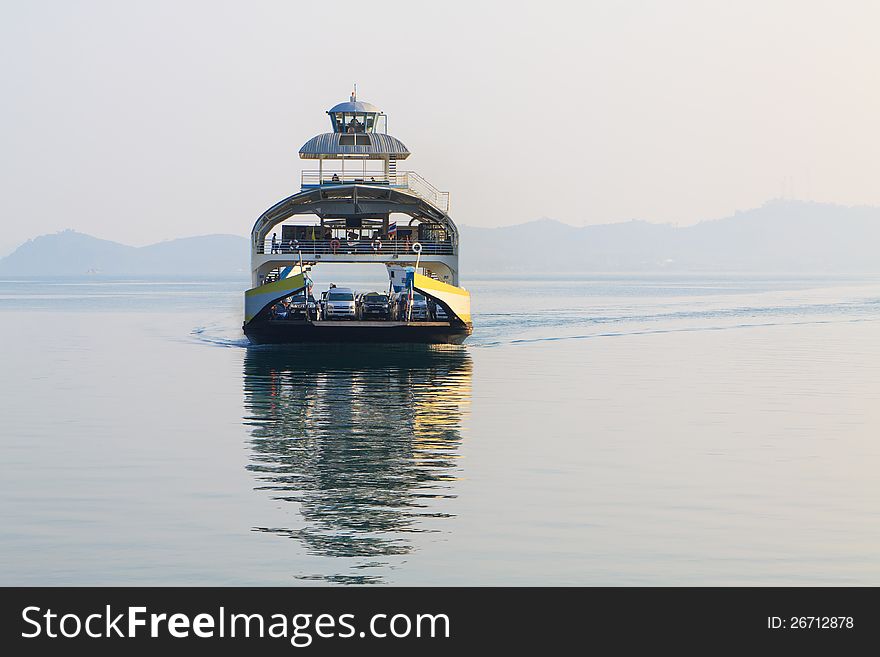 Large double-deck passenger ferry sails into the sea.