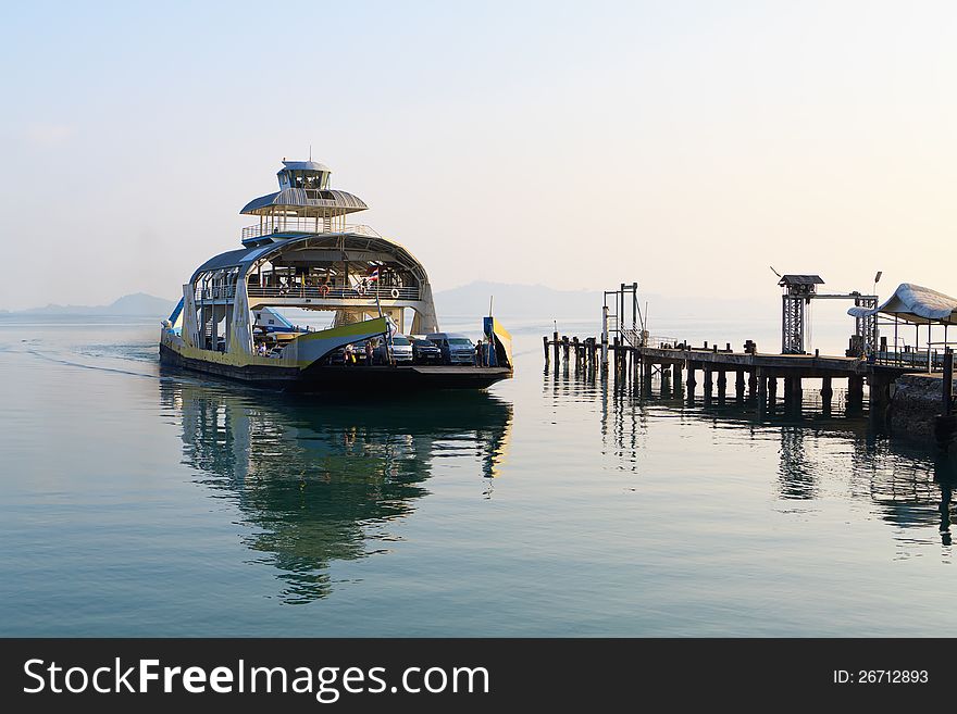 The ferry arrives at the empty ferry dock. The ferry arrives at the empty ferry dock.