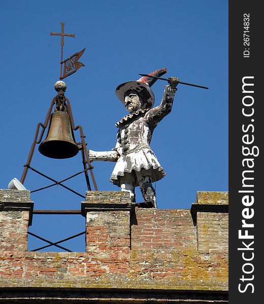 This image presents a small statue in top of a building. This image presents a small statue in top of a building.